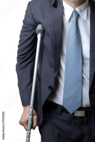 injured businessman with crutches, insurance concept photo