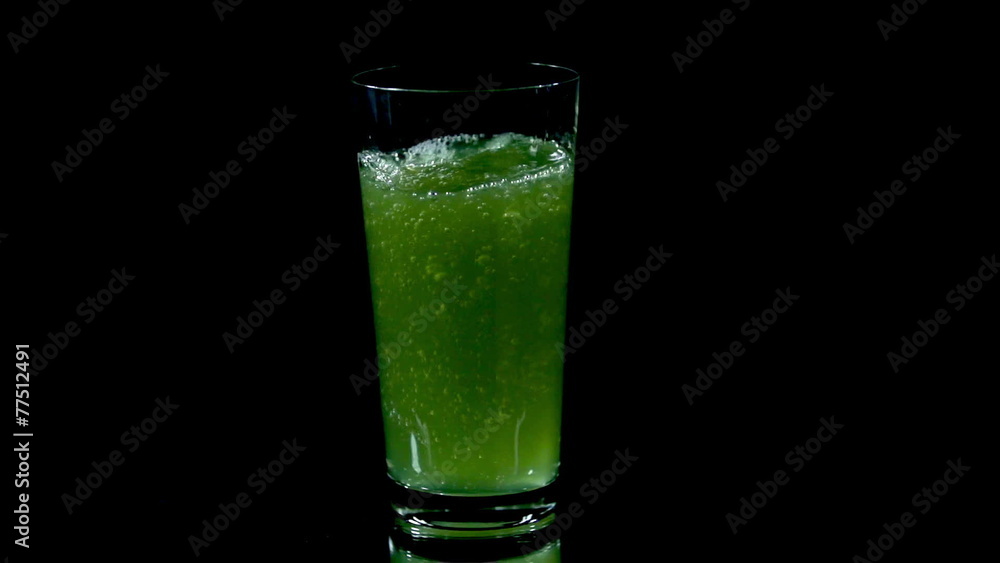 Greenish juice from vitamin tablets ready for drinking Greenish juice from vitamin tablets ready for drinking