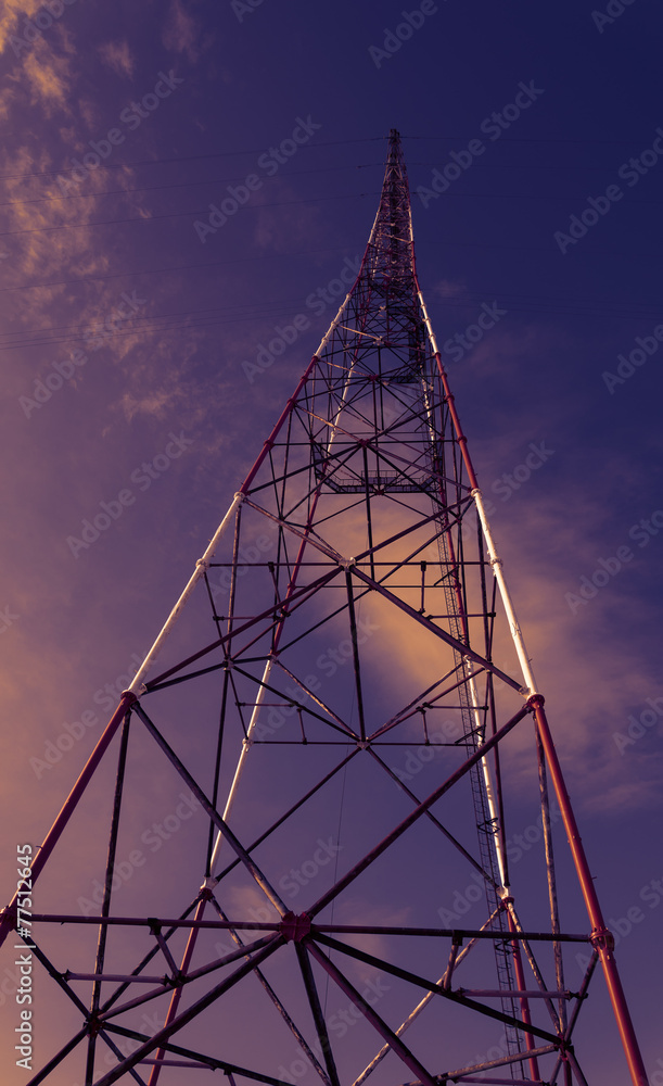 High-voltage tower against blue sky.