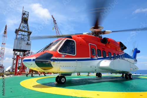 helicopter pick up passenger on the offshore oil rig platform