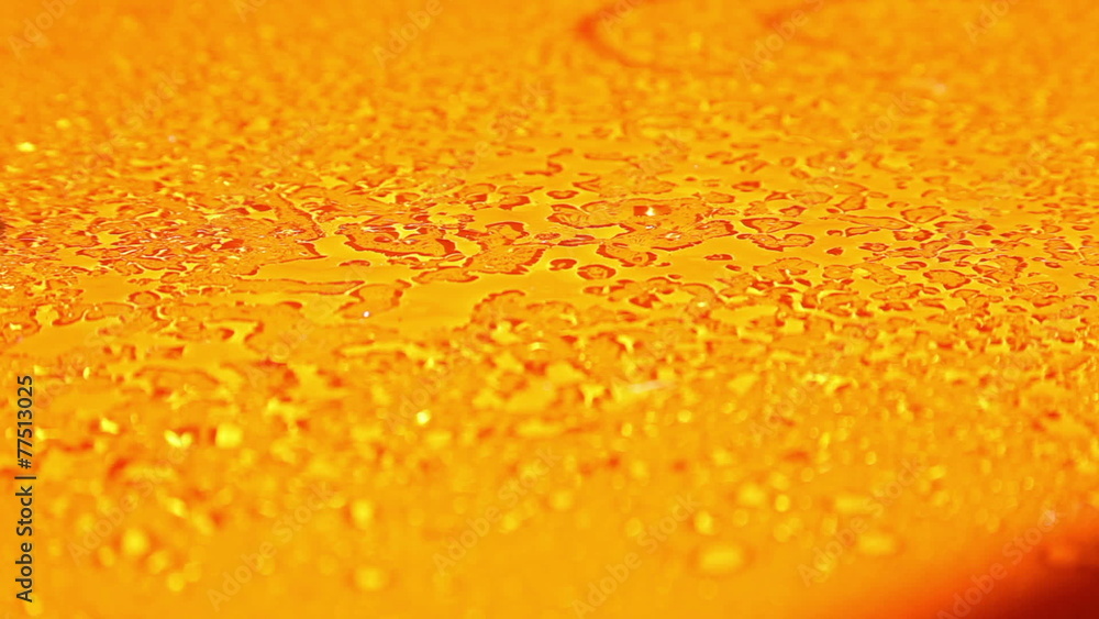 an orange surface that is sprayed with water an orange surface that is sprayed with water