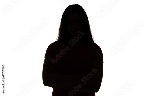 Silhouette of teenage girl with arms crossed