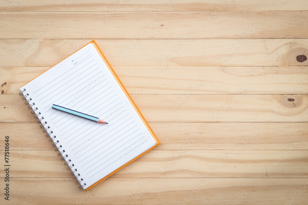 Notebook and pencil on wood Notebook and pencil on wood