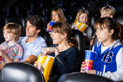 Families Watching Movie In Cinema Theater