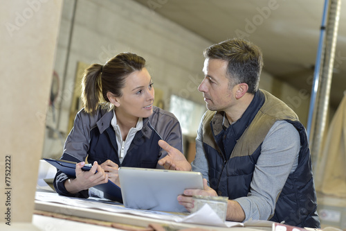 Woman with instructor in carpentry workshop photo