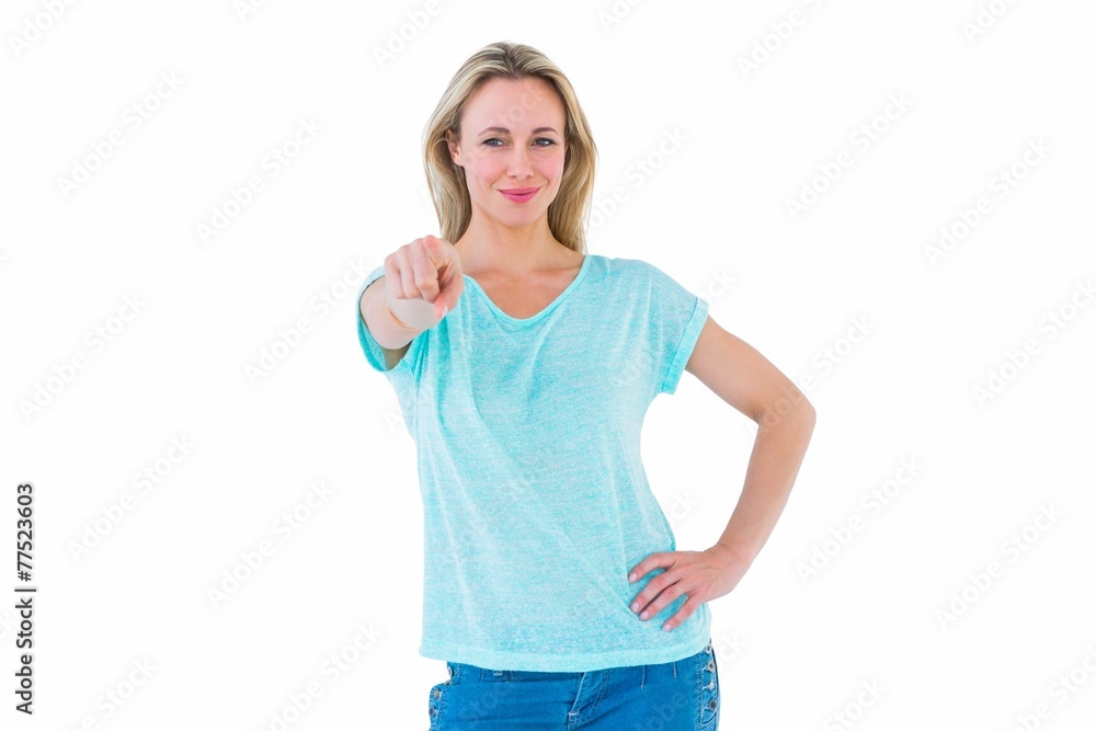 Fototapeta premium Smiling blonde standing and pointing at camera