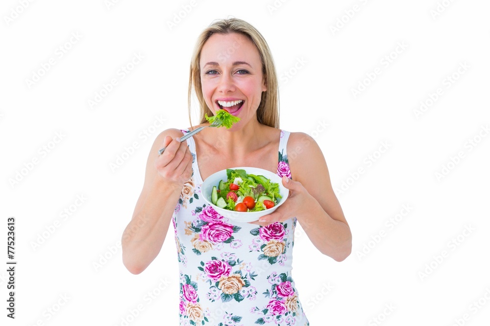 Smiling blonde eating bowl of salad Smiling blonde eating bowl of salad