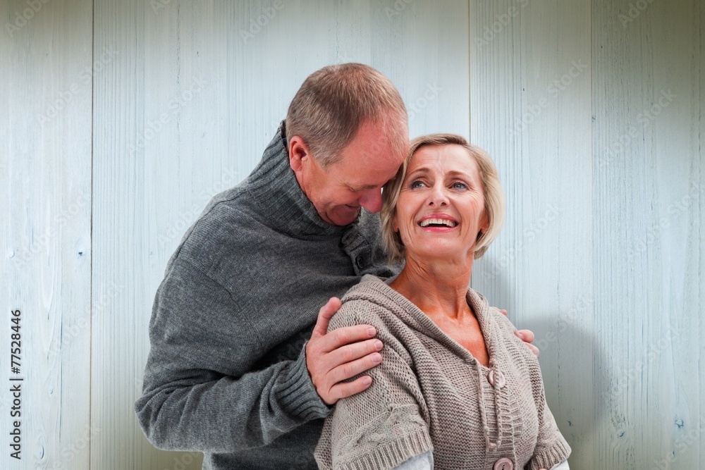 Composite image of happy mature couple in winter clothes Composite image of happy mature couple in winter clothes