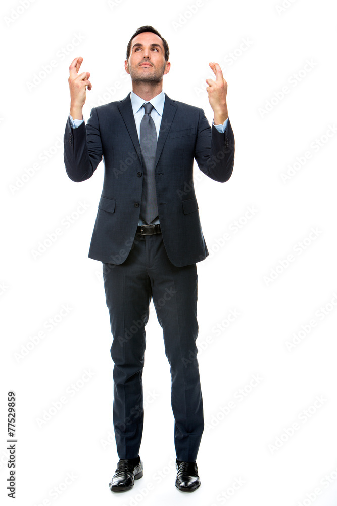 businessman looking above with fingers crossed businessman looking above with fingers crossed