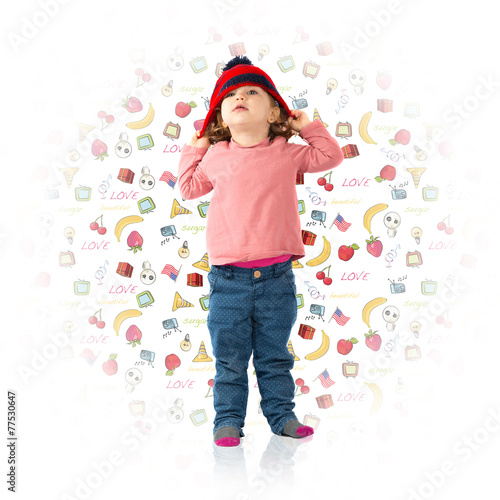 Little girl putting on a Christmas hat