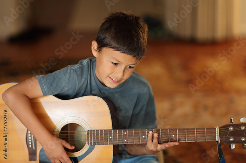 Young boy playing a guitar