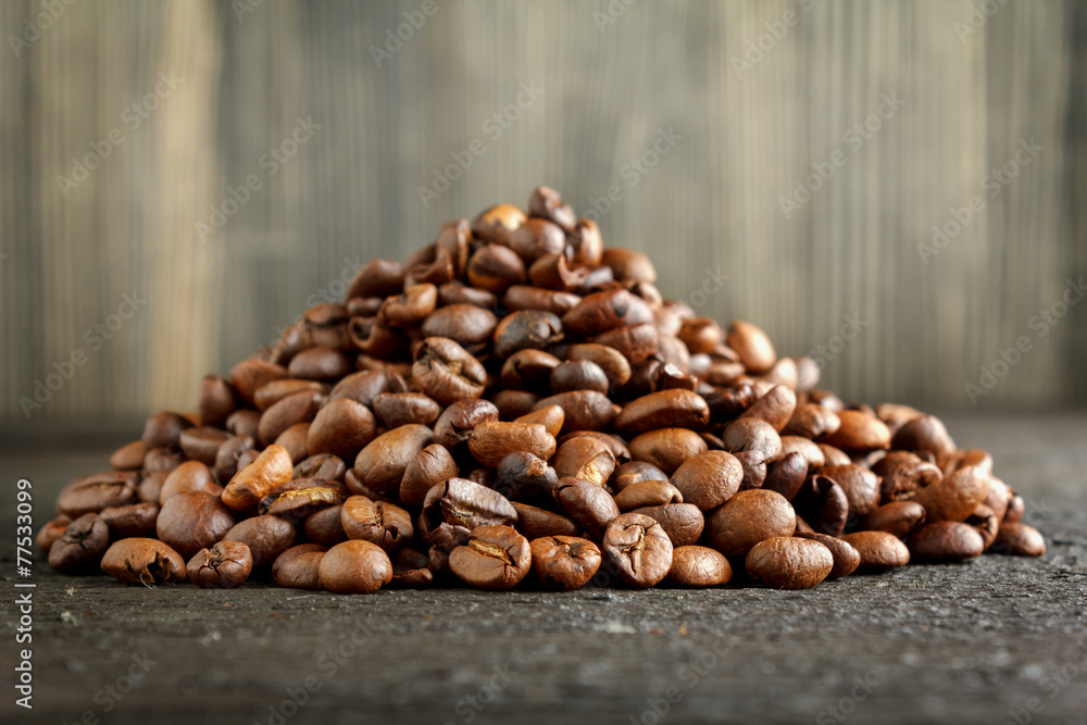 Heap of coffee beans on wood close-up Heap of coffee beans on wood close-up