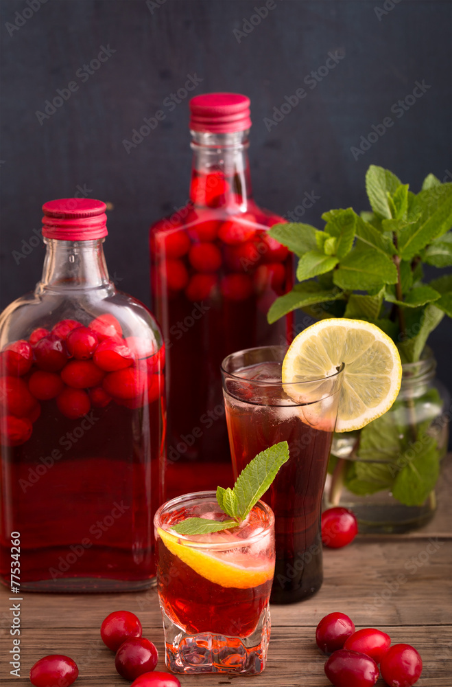 Shots and bottles of cranberry beverage Shots and bottles of cranberry beverage