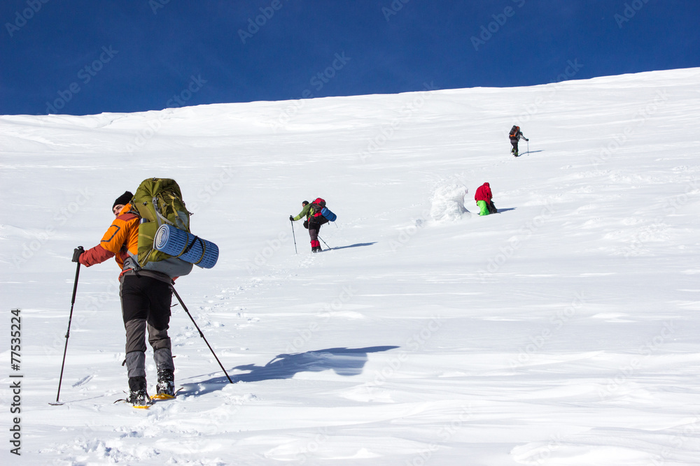 Winter hiking in the mountains on snowshoes .