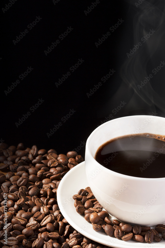 Fototapeta premium cup of steaming coffee with beans