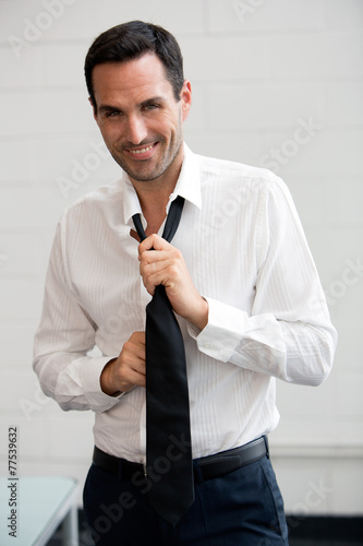 businessman taking off his tie photo