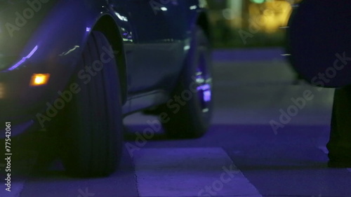 Guitar player walking across the pedestrian crossing and almost gets hit by car