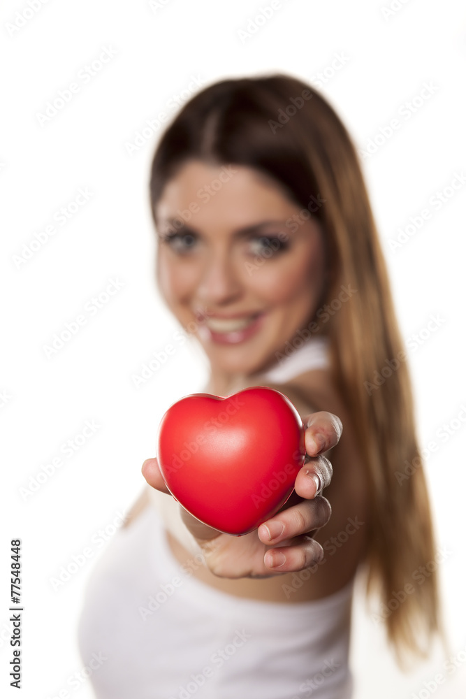 Attractive young woman showing red heart on white backgroung. Attractive young woman showing red heart on white backgroung.