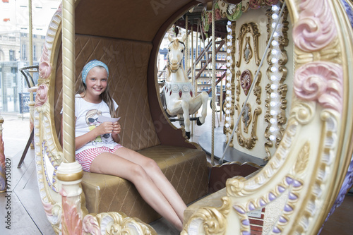 Ten-year girl riding a classic French carousel.