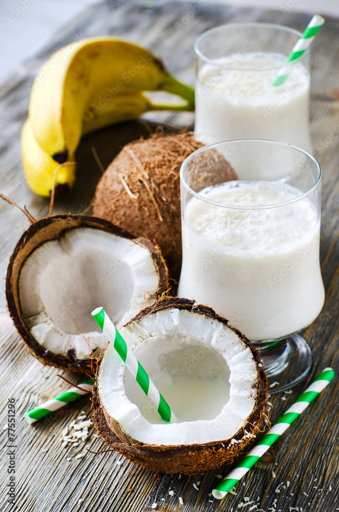 Coconut tropical smoothie drink with bananas on wooden backgroun Coconut tropical smoothie drink with bananas on wooden backgroun
