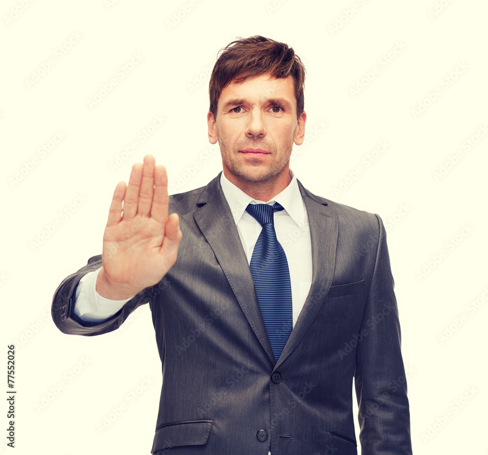 attractive buisnessman making stop gesture attractive buisnessman making stop gesture