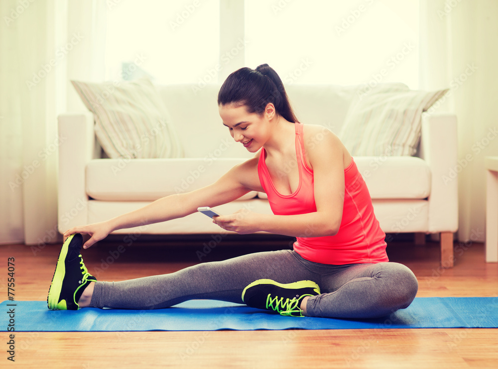 smiling teenage girl streching on floor at home smiling teenage girl streching on floor at home