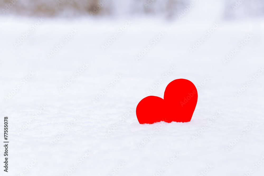 Single red heart lying on the snow, romantic love concept Single red heart lying on the snow, romantic love concept