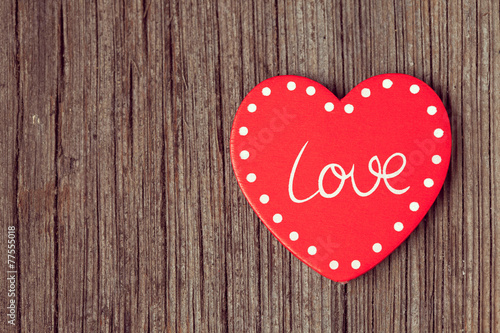 Red valentine's day heart on retro wooden background with vinta