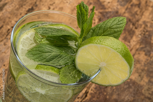 drink decorated with lime and mint leaves