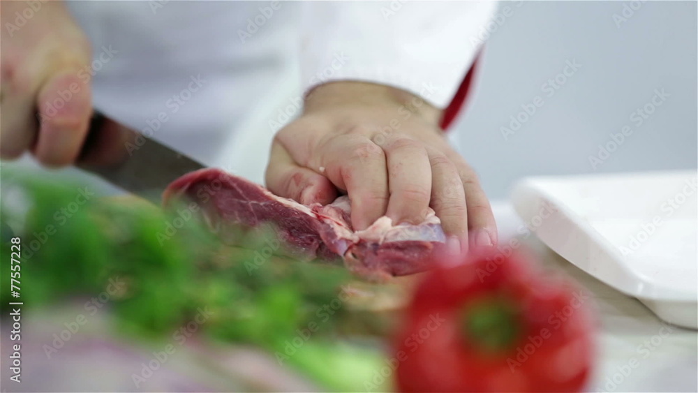 Sliding through chef's table while cutting red meat Sliding through chef's table while cutting red meat