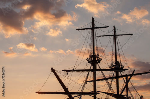 Masts of a pirate ship on sunset