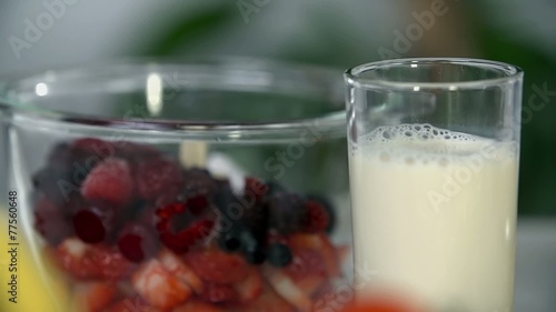 Milk near bowl of fruits photo