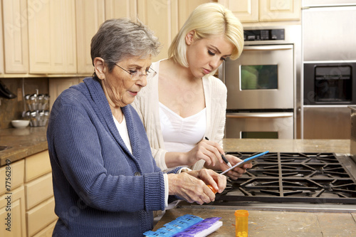 Senior Women Getting Help Organizing Her Prescription Medicine