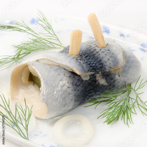 pickeld herring with dill on white photo