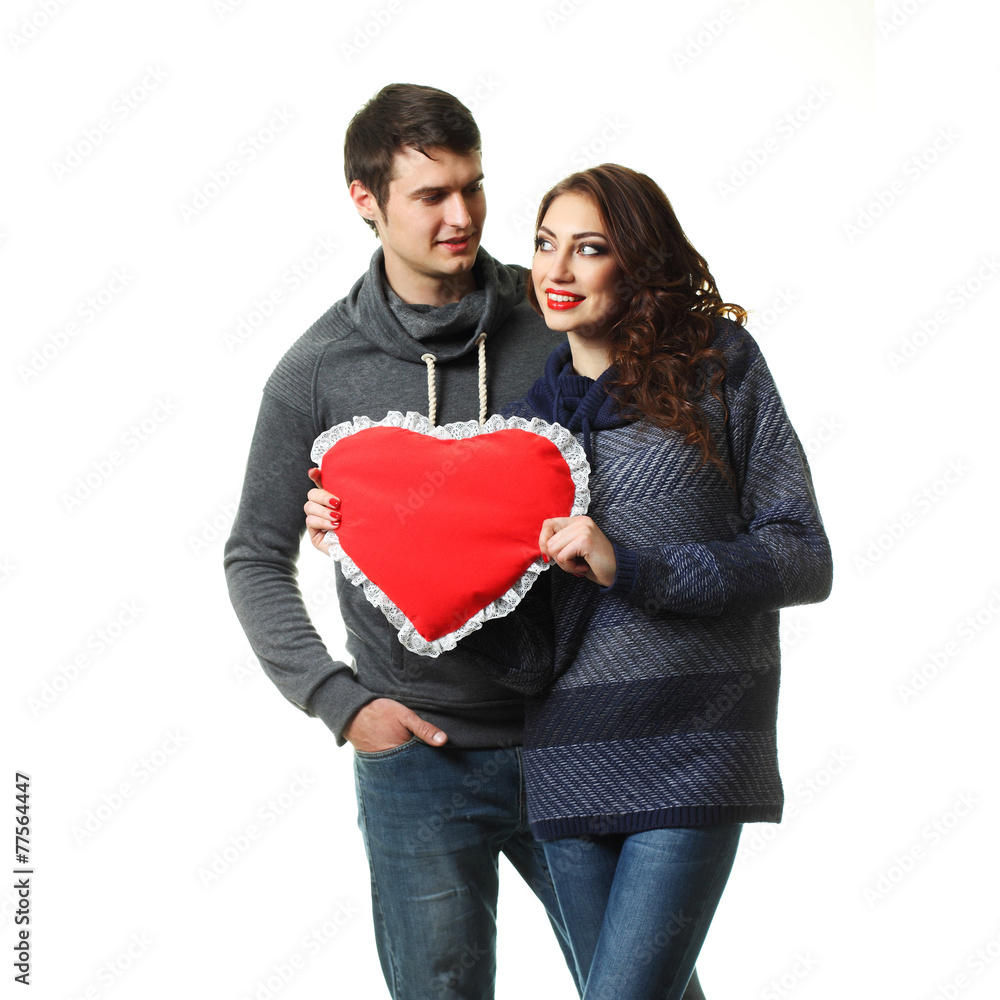 couple having fun with a pillow in the form of heart couple having fun with a pillow in the form of heart