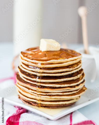 Pancake with butter and honey, a bottle of milk, dessert