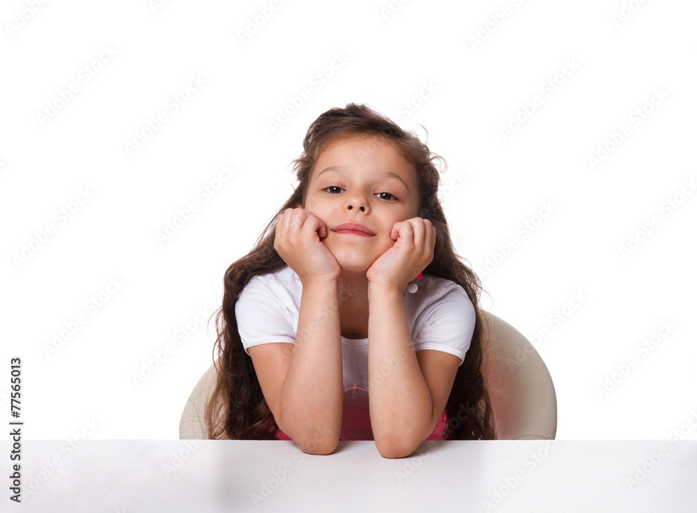 little girl sitting at the table. emotions concept