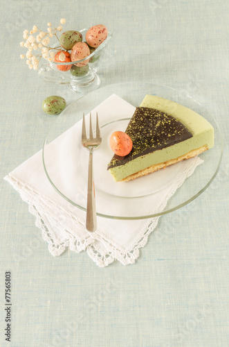 Piece of easter cake with tea matcha on glass plate