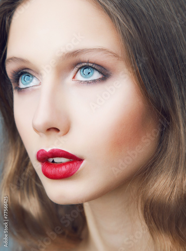 Emotive portrait of young beautiful woman with perfect make up.