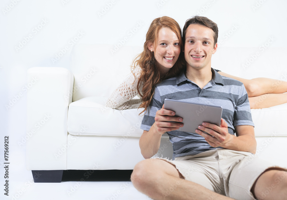 A beautiful Couple on sofa with digital tablet A beautiful Couple on sofa with digital tablet