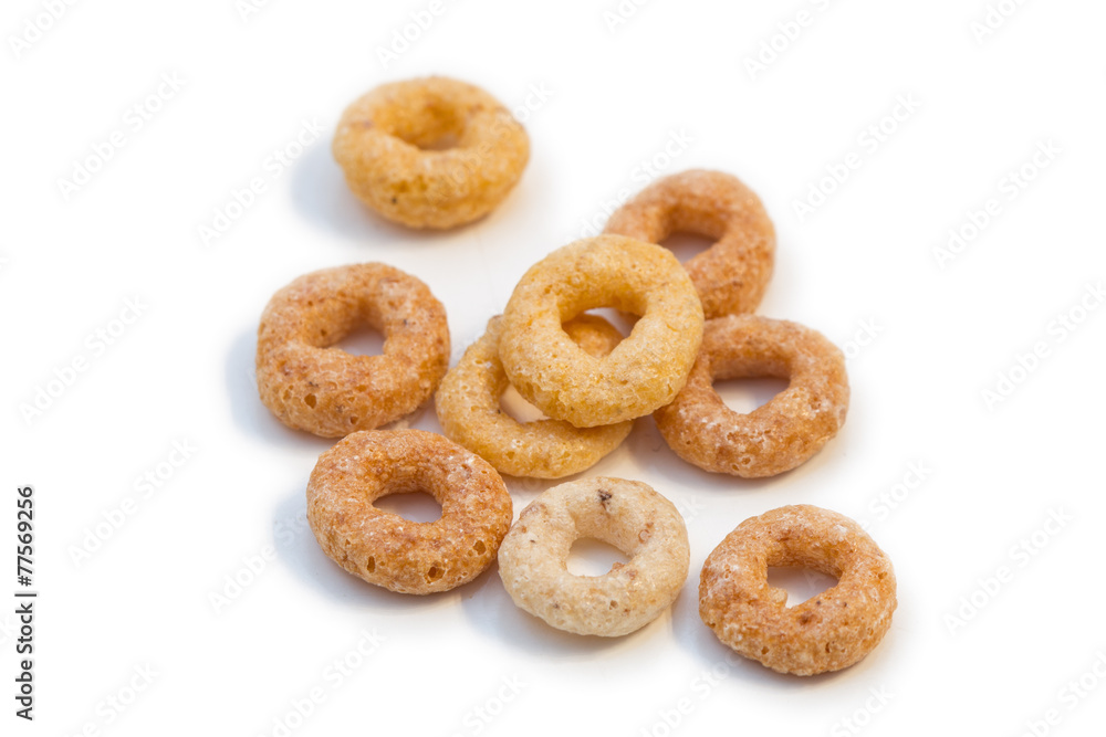 Closeup of a few round breakfast cereals isolated on white