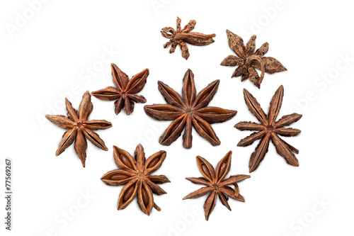 Closeup of several star anises isolated on white