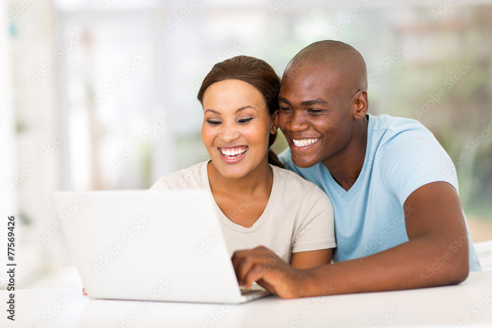 young african couple using laptop computer young african couple using laptop computer