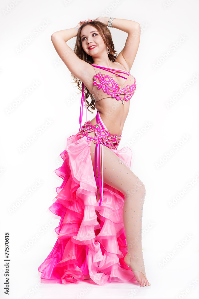 Beautiful belly dancer is wearing a pink costume Beautiful belly dancer is wearing a pink costume