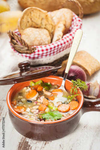 Rural vegetarian broth soup with colorful vegetables and rustic