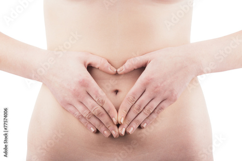 Young Woman with Heart Shaped Hands in front of Belly.