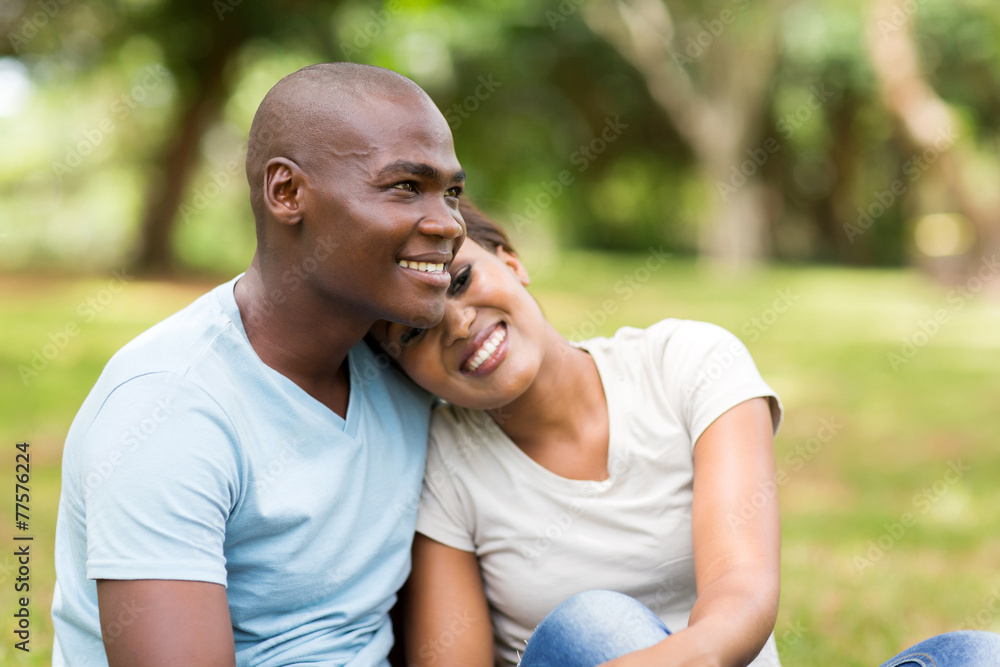 young african american couple sitting outdoors young african american couple sitting outdoors