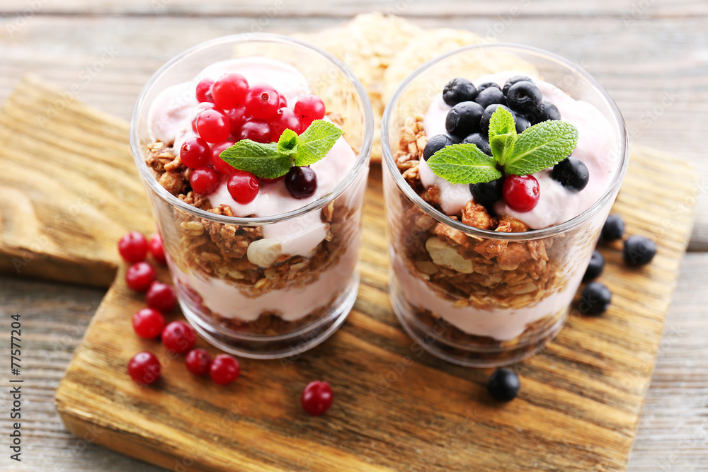 Healthy layered dessert with muesli and berries on table Healthy layered dessert with muesli and berries on table