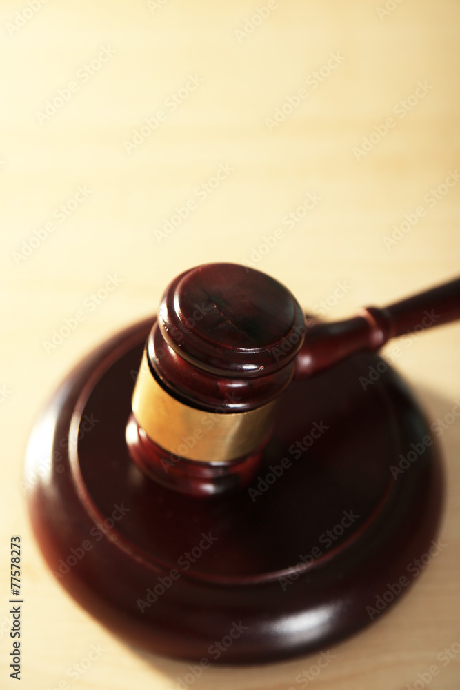 Wooden judges gavel on wooden table, close up Wooden judges gavel on wooden table, close up
