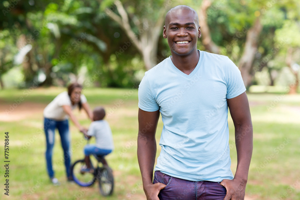 african american man standing in front of family african american man standing in front of family